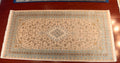 Decorative rug with intricate patterns on a wooden floor