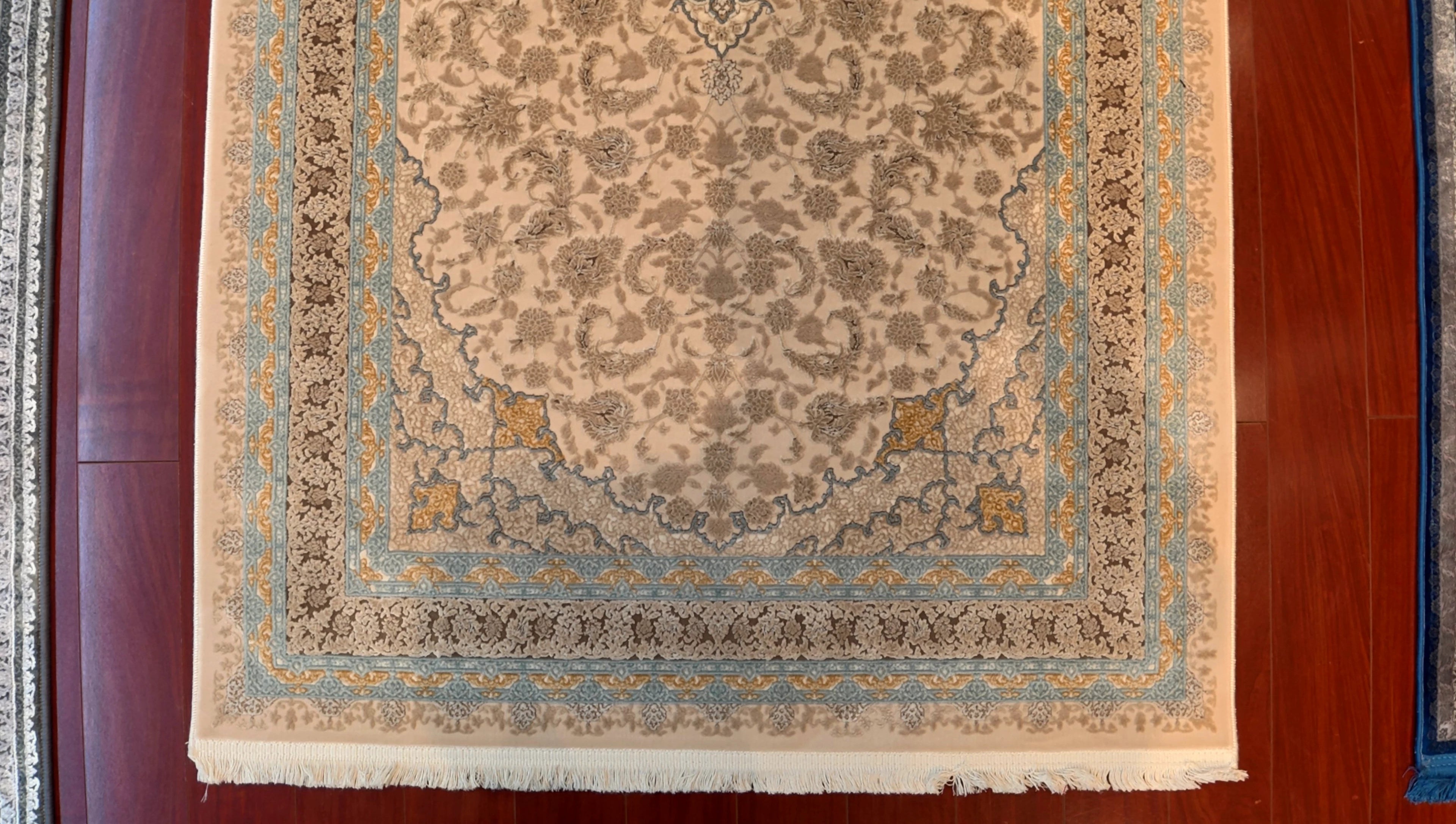 Decorative rug with intricate patterns on a wooden floor