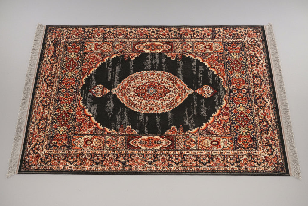 Decorative rug with intricate patterns on a wooden floor