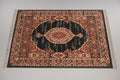 Decorative rug with intricate patterns on a wooden floor