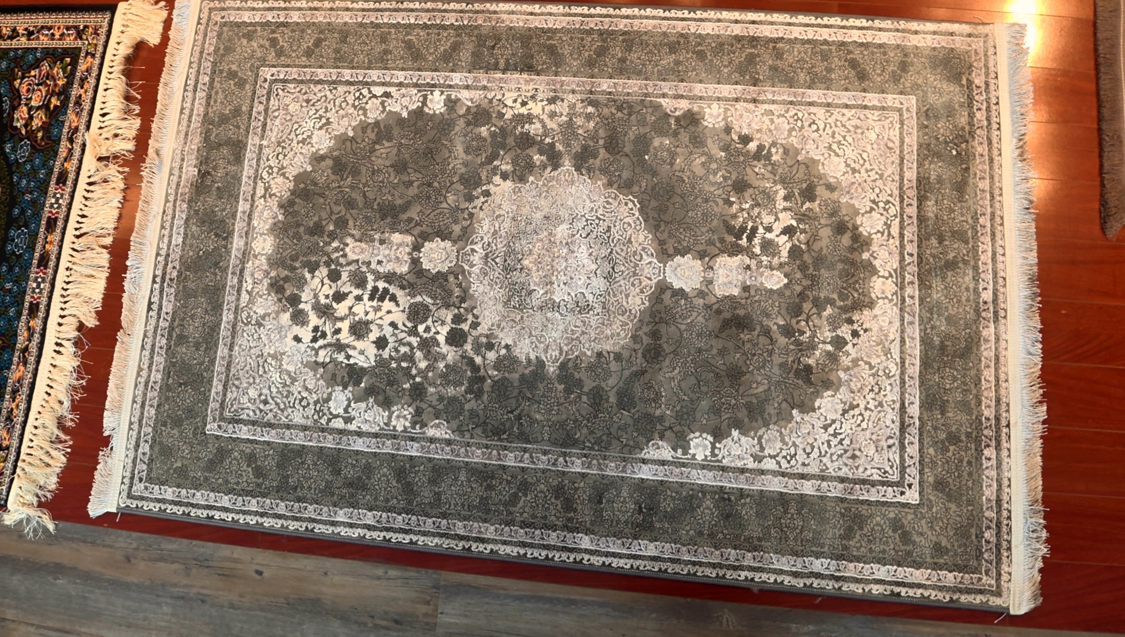 Decorative rug with intricate patterns on a wooden floor