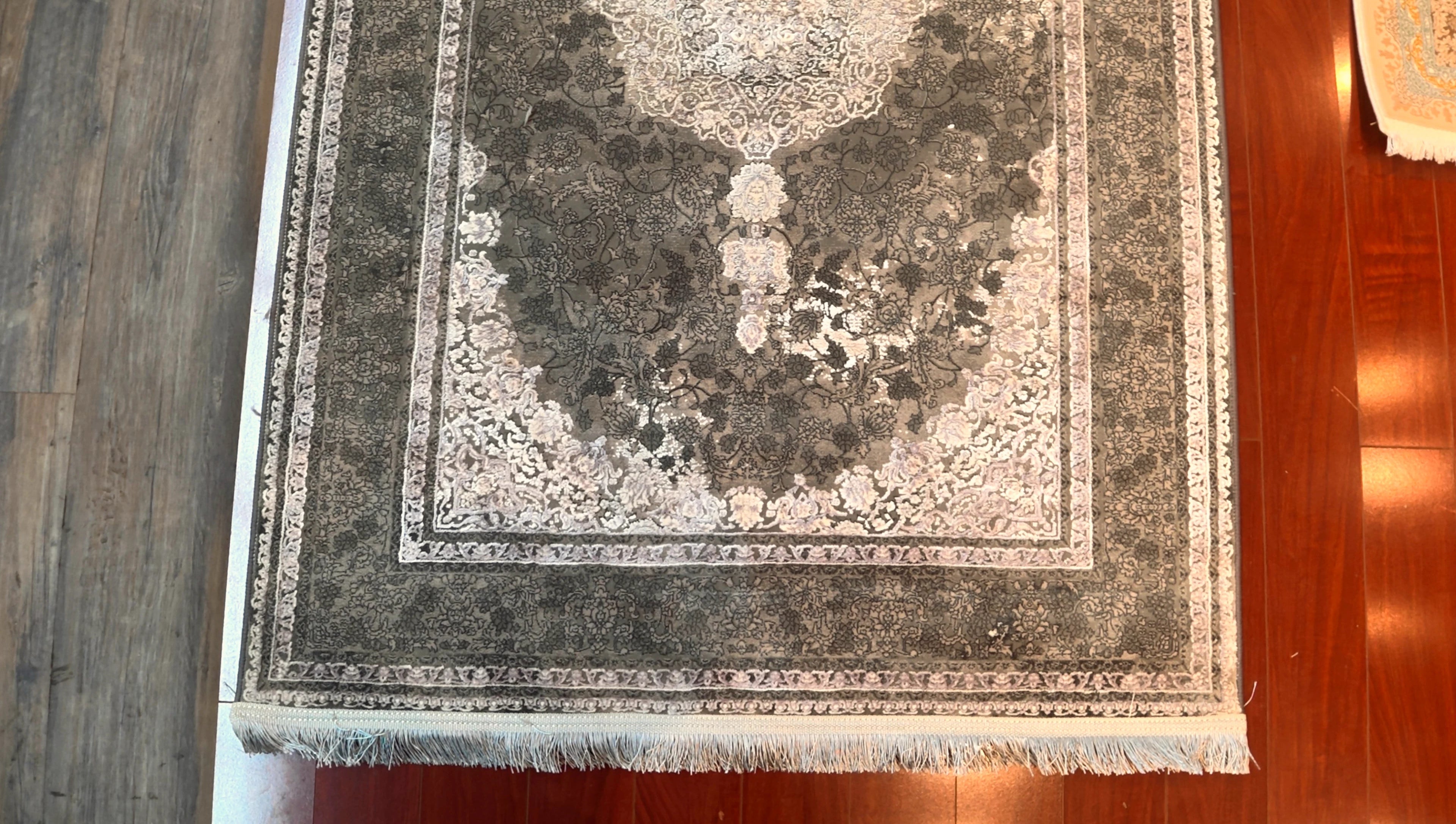 Decorative rug with intricate patterns on a wooden floor